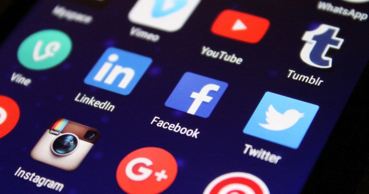 Person scrolling Facebook on a phone checking competition legitimacy