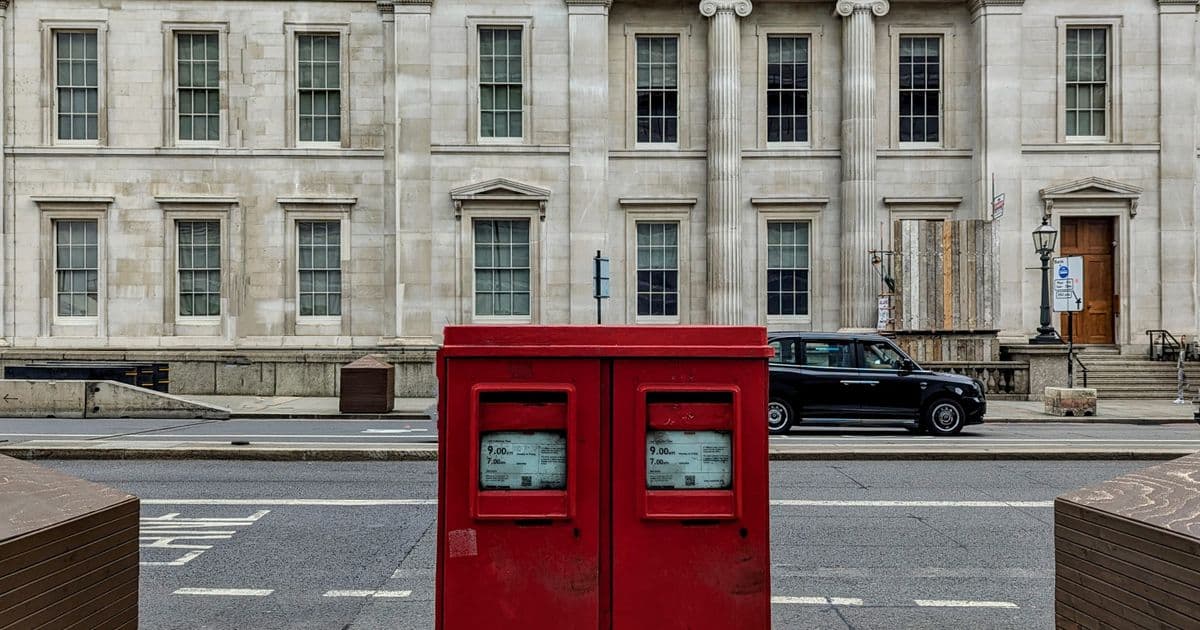 Classic red Royal Mail postboxes on a London street